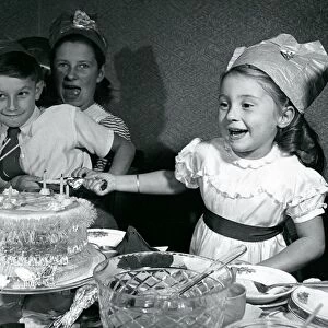 Kids pull crackers at Christmas party 1950 Infront of xmas cake