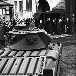 King George VI and Queen Elizabeth, pictured watching tank display whilst on their royal