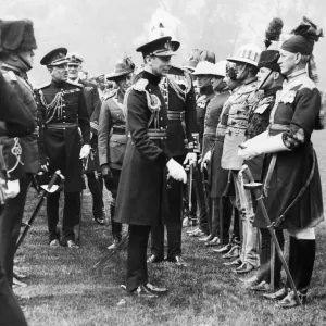 King George VI seen here presenting Coronation medals to members of the Oversea