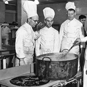Kitchen workers in the West of England Aeroplane Works. Chefs around a large tub