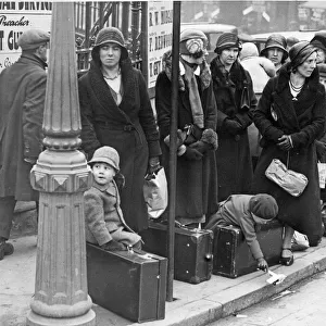 Ladies with their young charges await the bus to take them on their holidays at Easter