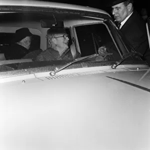 Lady Churchill leaves for a drive. A momentary smile as she gets tangled in the car