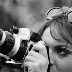 A lady festival goer takes a picture with her Nikon Camera at The Windsor Jazz Festival A lady festival goer takes a picture with her Nikon Camera at The Windsor Jazz Festival