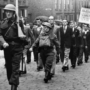 The latest recruits carry a poster in a march of the 77th Lancashire (Bootle