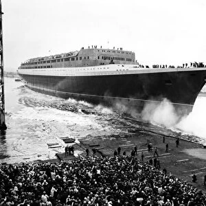 The launching is compete of the Queen Elizabeth II, it makes a splash as the bows enter
