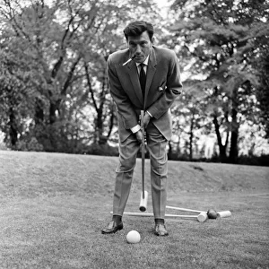 Laurence Harvey has a quick game of croquet on the lawn of the house in Priesthorpe Lane