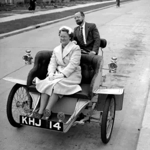 Laurence Mathew sitting in his veteran car with his wife driving behind May 1956