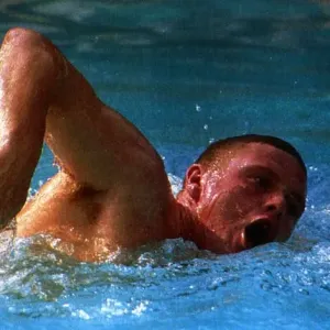 Lazio and England footballer Paul Gascoigne swimming in a pool in Rome as he battles to