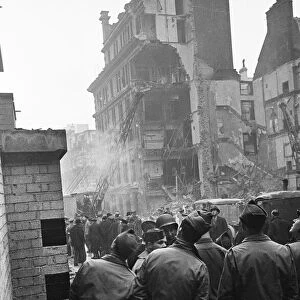 LCC and Civil Defence workers seen here clearing up following a V2 explosion at the Red