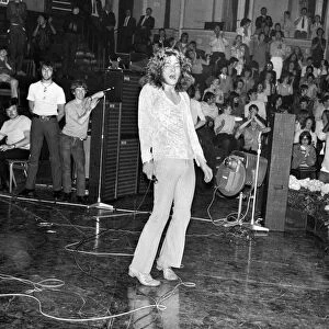 Lead singer Robert Plant of Led Zeppelin rock group performing on stage during a concert