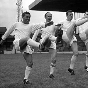 Leeds United players Bobby Collins, Mason, Lawson, and Storrie high kicking during