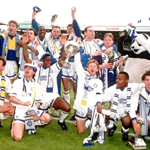 Leeds United team celebrate with the league division one championship trophy