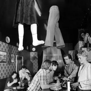 Legs coming through the roof a local pub as customers order more drinks from the bar Legs coming through the roof a local pub as customers order more drinks from the bar