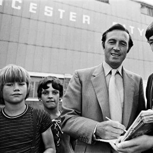 Leicester City manager Jimmy Bloomfield signs autographs for fans outside Filbert Street