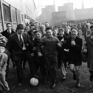 Leicester town folk play football before the 1961 FA Cup Final between Leicester City