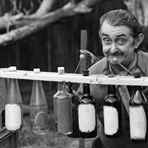 Len Austin and his boozaphone, a musical instrument made from old beer and wine bottles