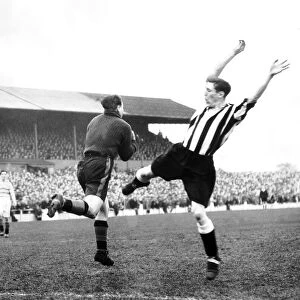 Len Shackleton of Newcastle (right) is beaten to the ball by Doncaster goalkeeper