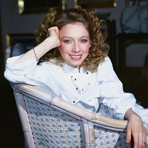 Lena Zavaroni sitting in whicker chair, wearing a white jump suit, aged 22. December 1985