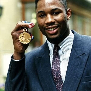 Lennox Lewis boxer holding gold medal April 1989