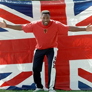 Lennox Lewis poses with a hug England flag ahead of his WBC world title fight with Tony
