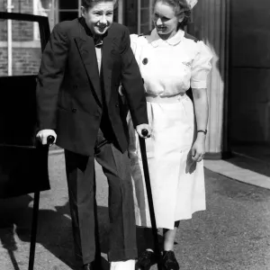 Lester Piggott with a nurse and broken foot or toe. 15th September 1951 Lester Piggott with a nurse and broken foot or toe. 15th September 1951