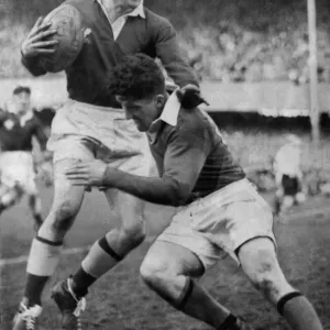 Lewis Jones avoids a tackle from Noel Henderson of Ireland at Landsdowne Road during