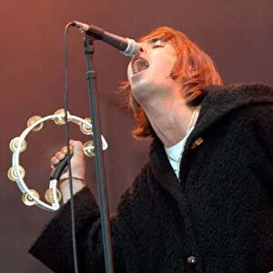 Liam Gallagher singing into microphone during the Oasis concert at Balloch Country Park