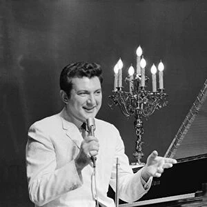 Liberace entertains the audience at The Royal Variety Show held in the presence of her