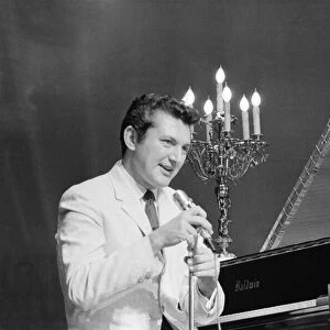 Liberace entertains the audience at The Royal Variety Show held in the presence of her