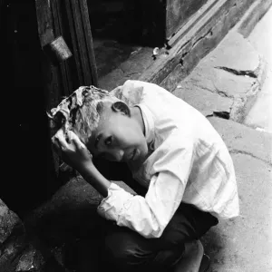 Print of a Child Washing Hair Over a Drain in 1960s Hong Kong