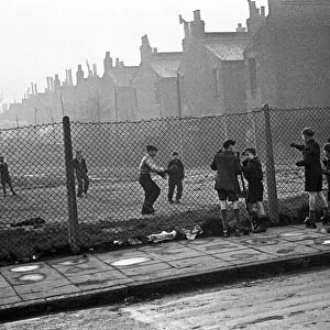 Life in the Mirror Our Gang. 19th January 1954 Boys playing football watched on by