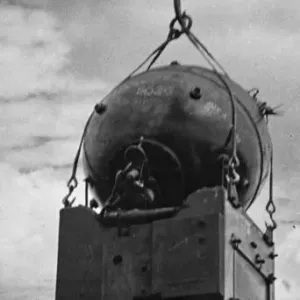 A mine is lifted out of the water and placed on a ship's deck, circa 1942 A mine is lifted out of the water and placed on a ship's deck, circa 1942
