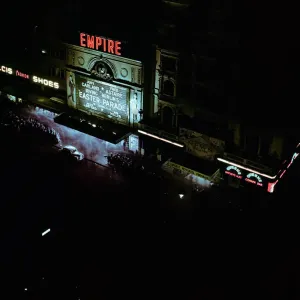 Lights of london. Empire cinema illuminated as crowds queue to watch the film Lights of london. Empire cinema illuminated as crowds queue to watch the film