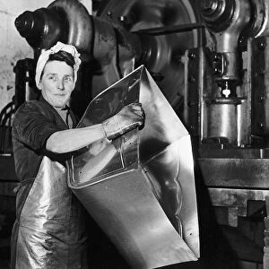Lily Hill at her giant press stamping out the metal foundations of baby prams at a