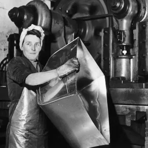 Lily Hill at her giant press stamping out the metal foundations of baby prams at a