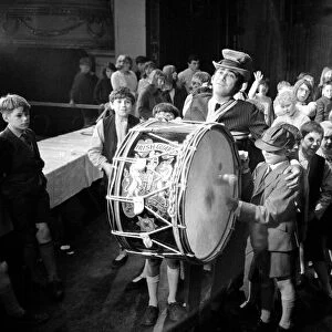 Lionel Bart who wrote "Oliver"plays the big drum from the Irish Guards as he