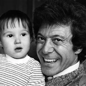 Lionel Blair pictured at home with his son. 19th October 1983