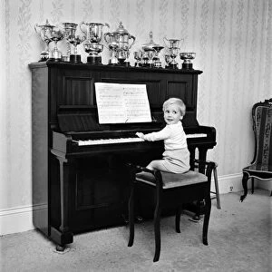 A little boy playing the piano at his home. November 1969 Z10653-001