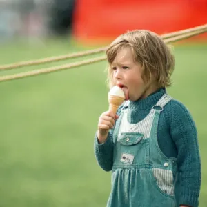 A little girl enjoys an ice-cream at Kirkleatham Country Fayre. 1st August 1993