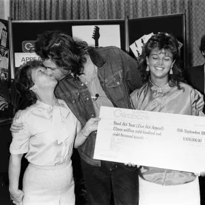 A black and white print of Bob Geldof holding a giant cheque A black and white print of Bob Geldof holding a giant cheque