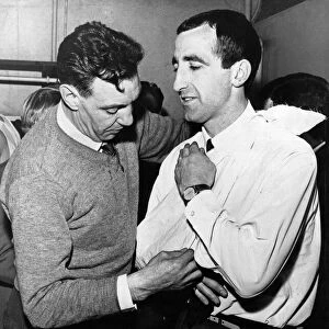 Liverpool assistant trainer Joe Fagan puts the injured right shoulder of Gerry Byrne in a