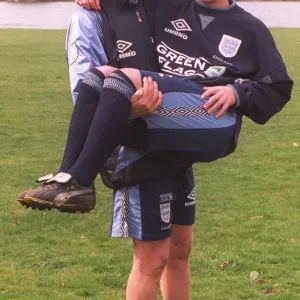 Liverpool defender Mark Wright carries his fellow club teammate Robbie Fowler in his Liverpool defender Mark Wright carries his fellow club teammate Robbie Fowler in his