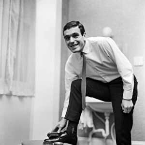 Liverpool and England footballer Ian Callaghan polishes his shoes ahead of his side