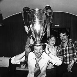 Liverpool FC player David Fairclough with the European cup on his head on the train