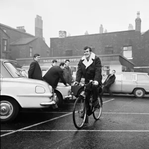 A black and white print of Alf Arrowsmith arriving at Anfield on a bicycle A black and white print of Alf Arrowsmith arriving at Anfield on a bicycle