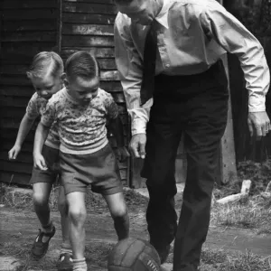 Liverpool footballer Billy Liddell playing football with his twin boys in the back garden Liverpool footballer Billy Liddell playing football with his twin boys in the back garden