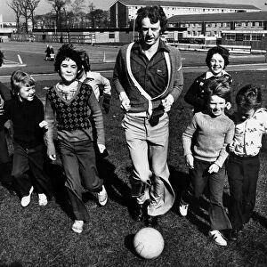 Liverpool footballer David Fairclough finds time for a kick about with some of