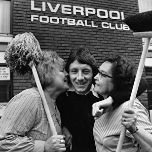 Liverpool footballer Jimmy Case gets an extra special welcome from two workers at Anfield