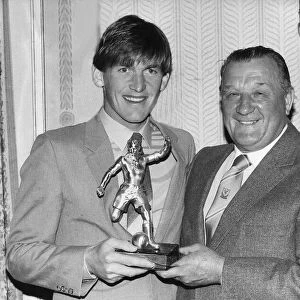 Liverpool footballer Kenny Dalglish recieves an award from manager Bob Paisley