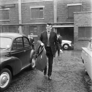 Liverpool goalkeeper Tommy Lawrence picks up his new suit ahead of the team